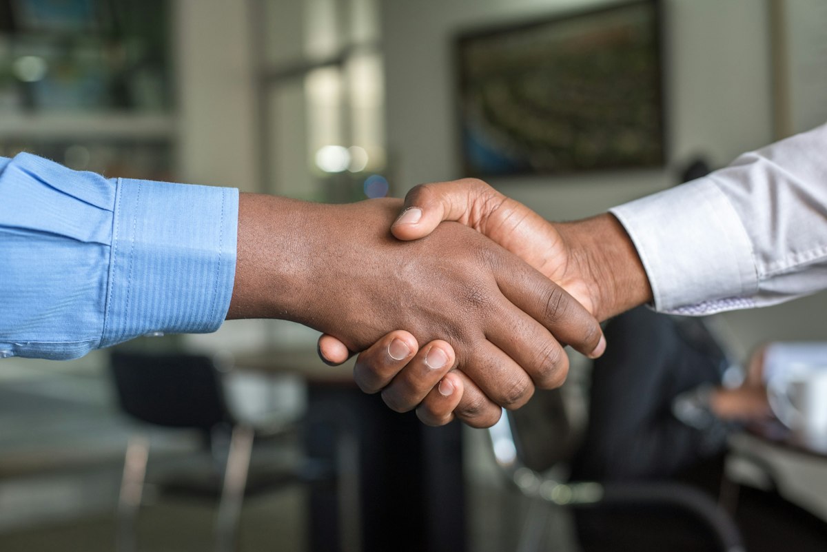 An advisor and homeowner shaking hands